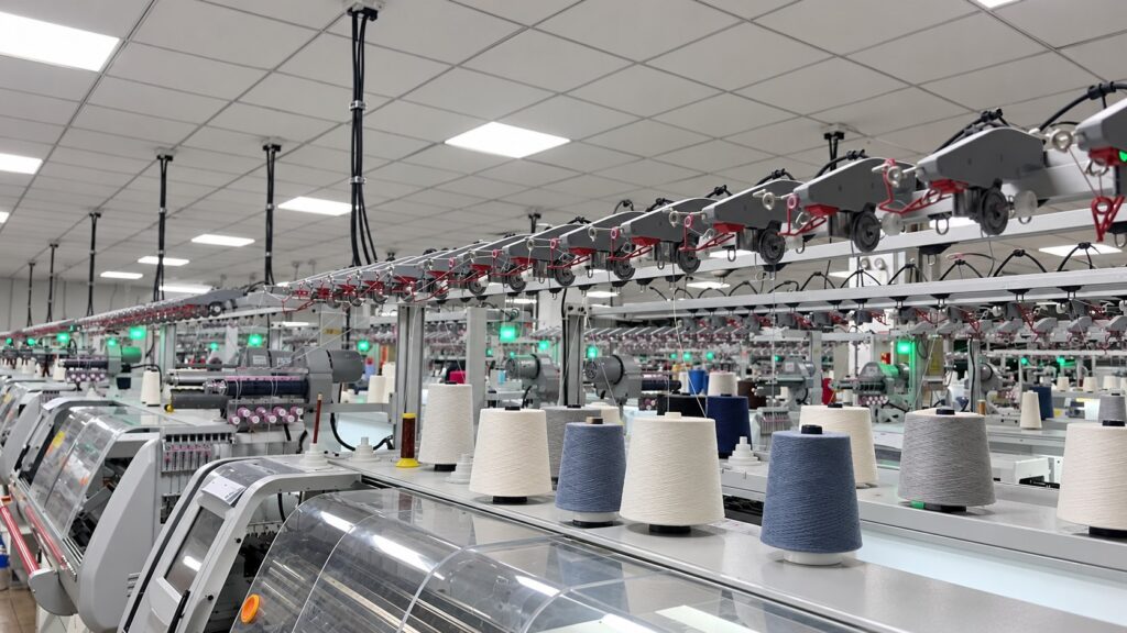 AI-assisted image: computerized knitting machines and yarn feeds