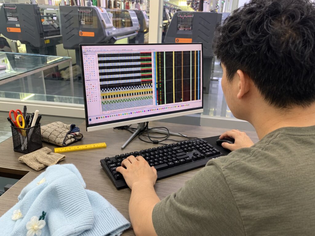 AI-assisted image: knit-pattern programming at a development workstation