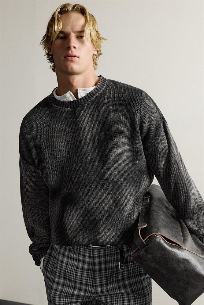 Relaxed dark crew-neck sweater, alternate view.