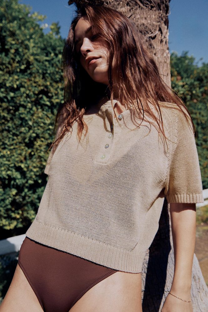 Beige short-sleeve knit top outdoors.