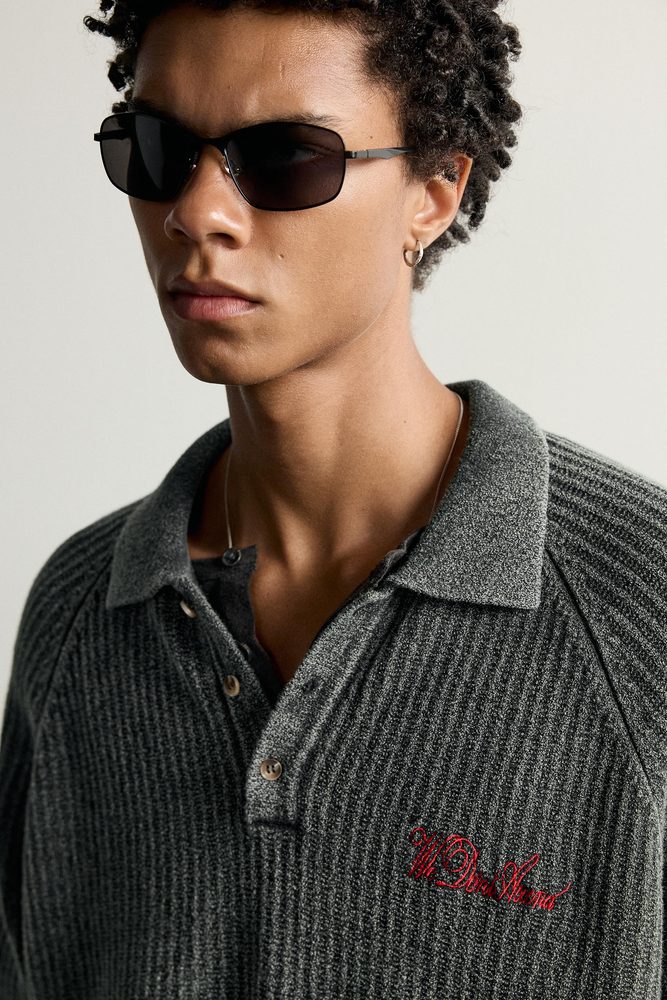 Dark collared knit shirt, close-up.