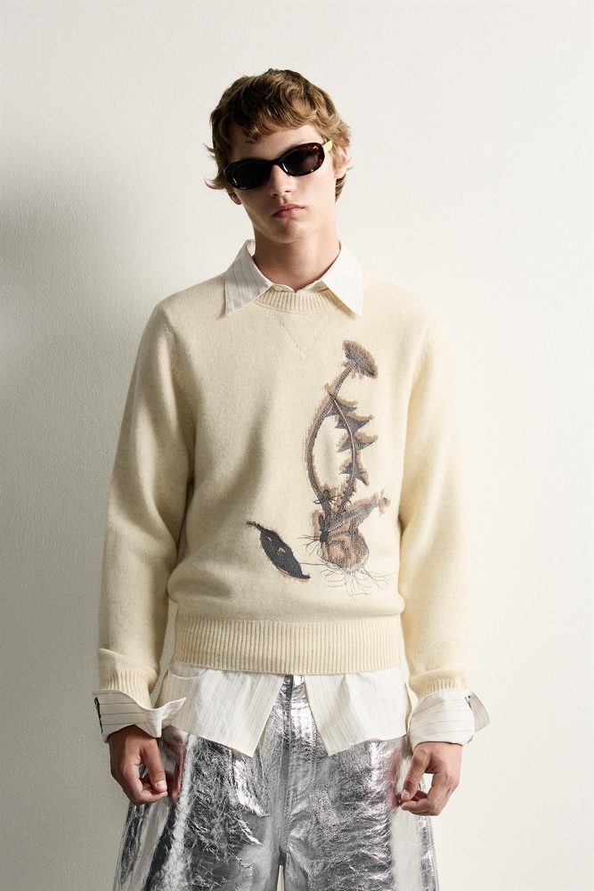 Cream sweater with a large graphic motif.