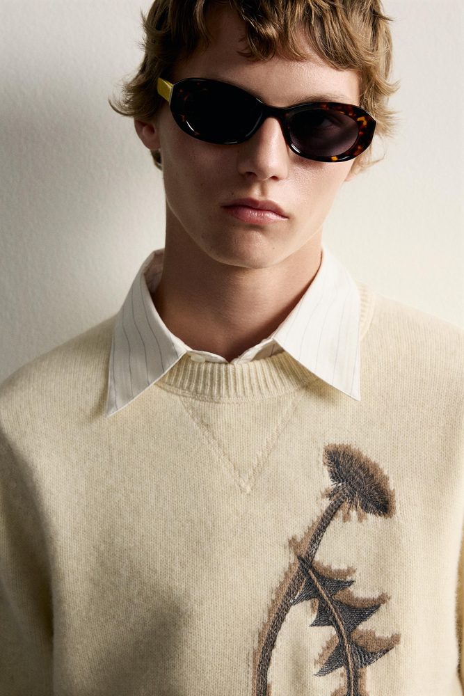 Cream graphic sweater, neckline and shoulder view.