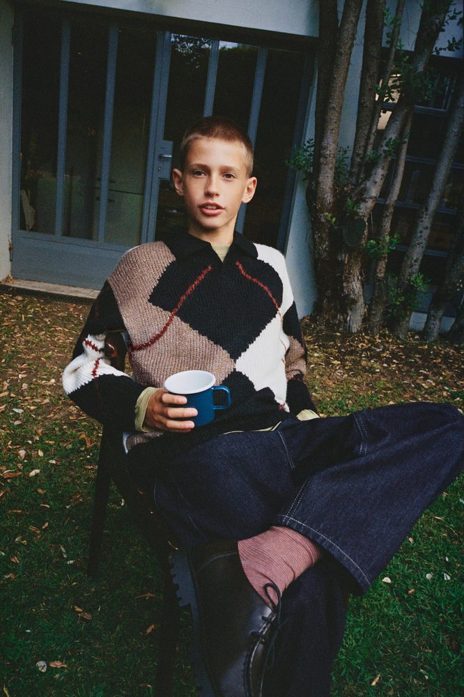 Black and cream patterned knit garment styled outdoors.