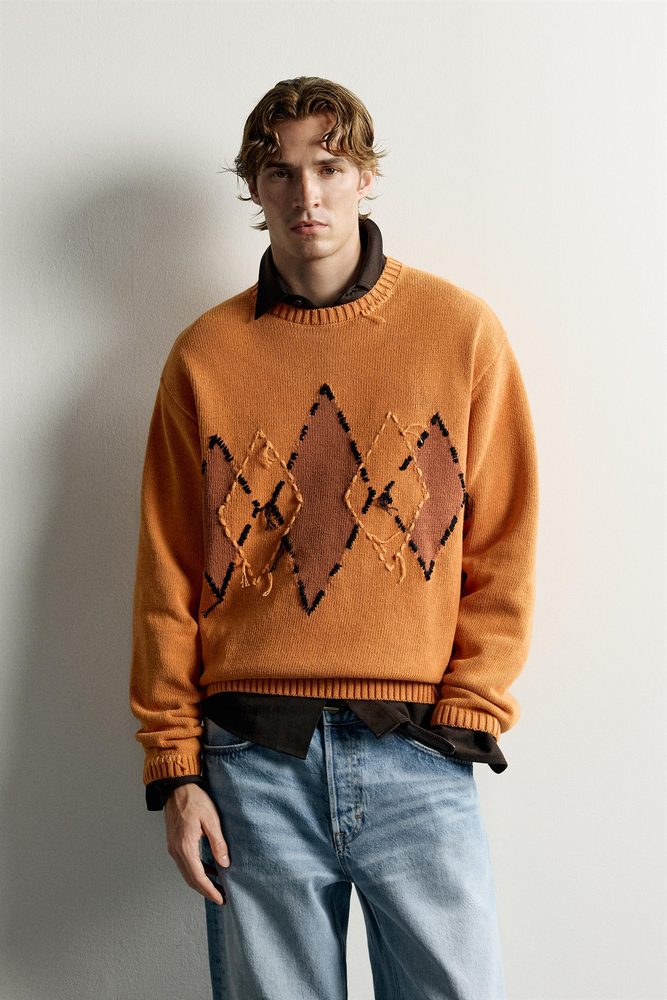 Orange diamond-pattern crew-neck sweater.