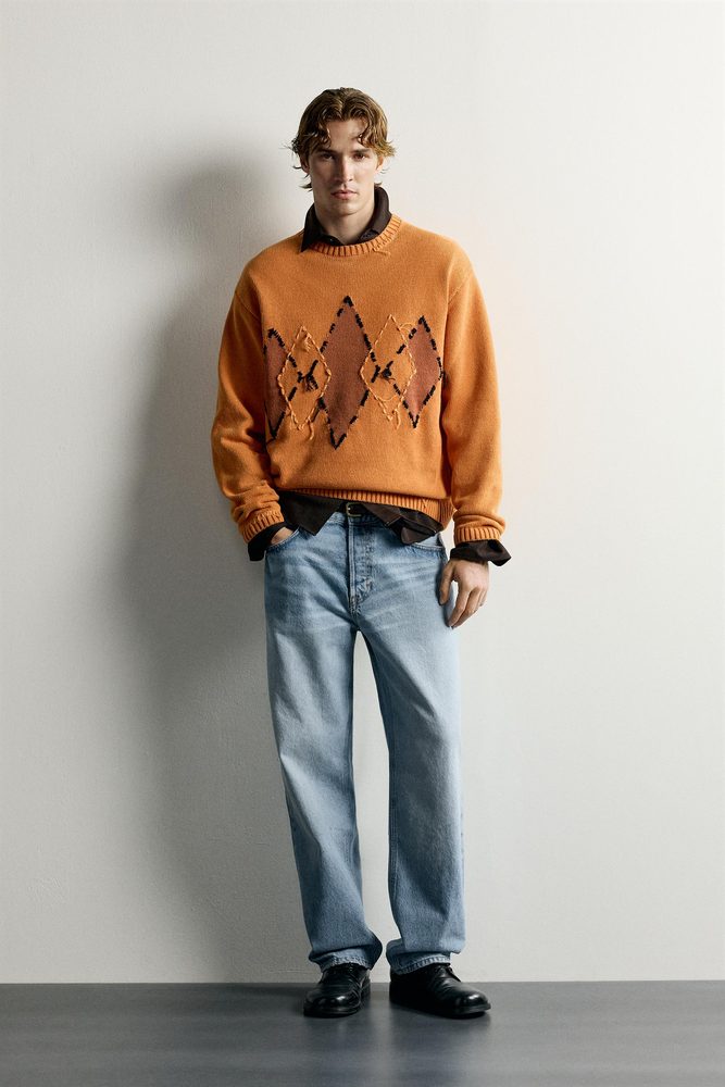 Orange patterned sweater styled with denim.