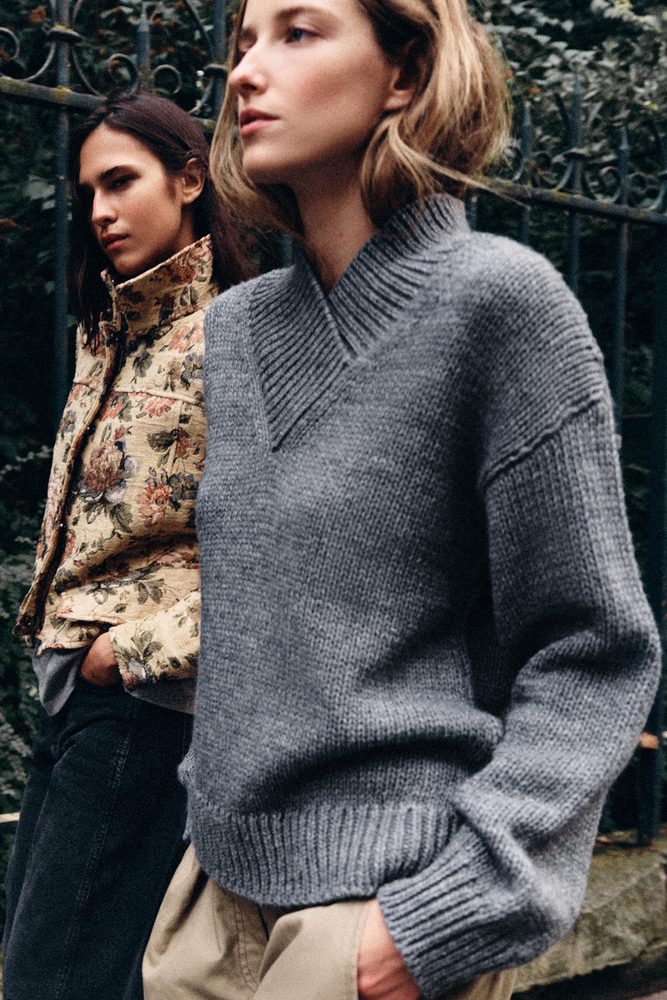 Gray fine-knit crew-neck sweater outdoors.
