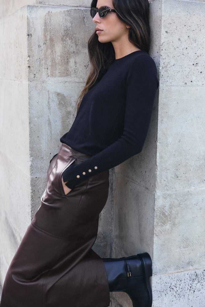 Navy ribbed knitted top, side view.