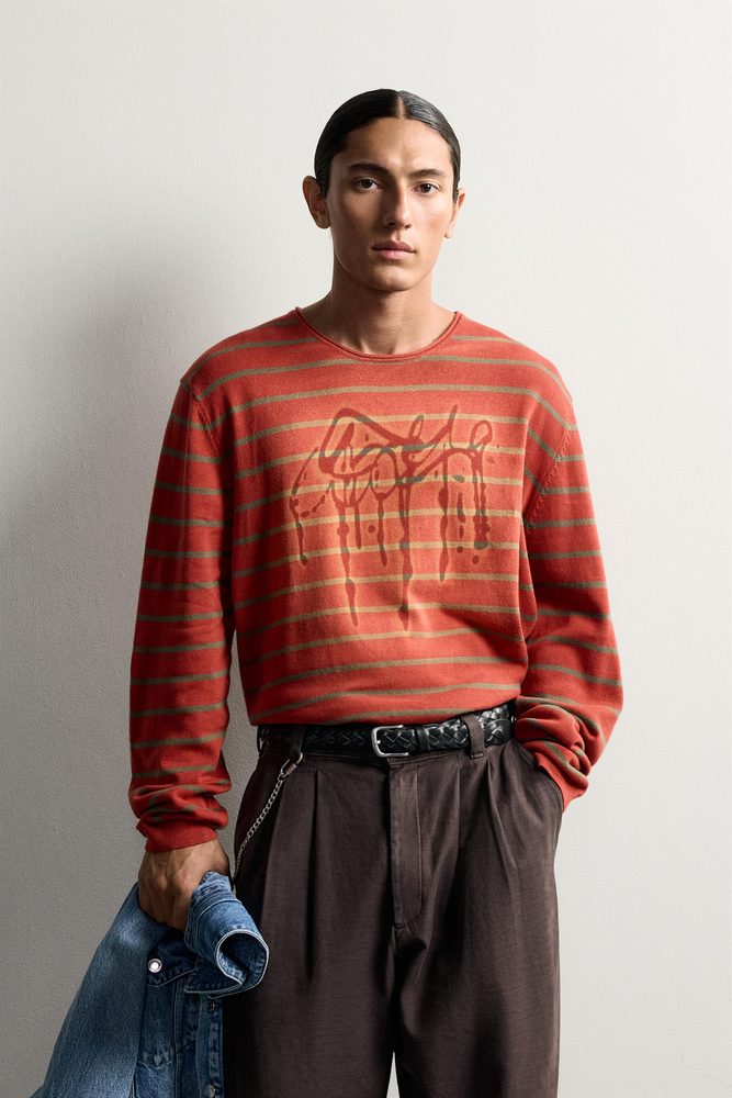 Red graphic striped sweater, front view.