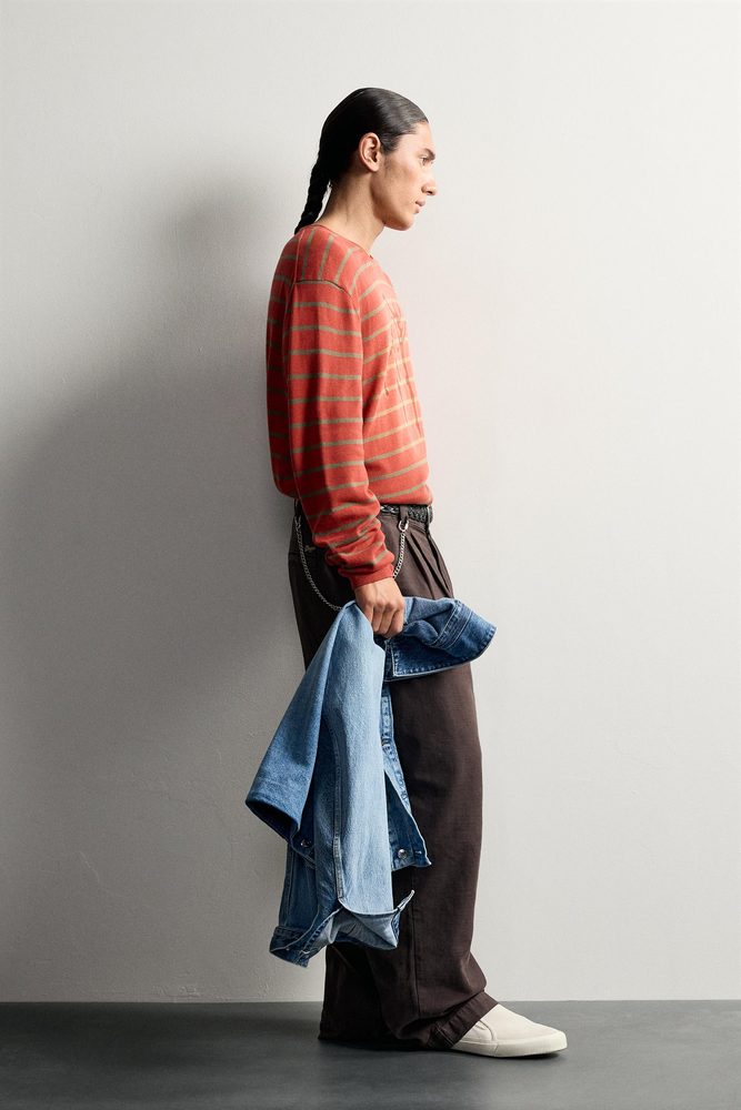 Red graphic sweater, side view.