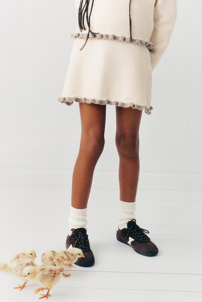 Cream knitted outfit, skirt and hem detail.