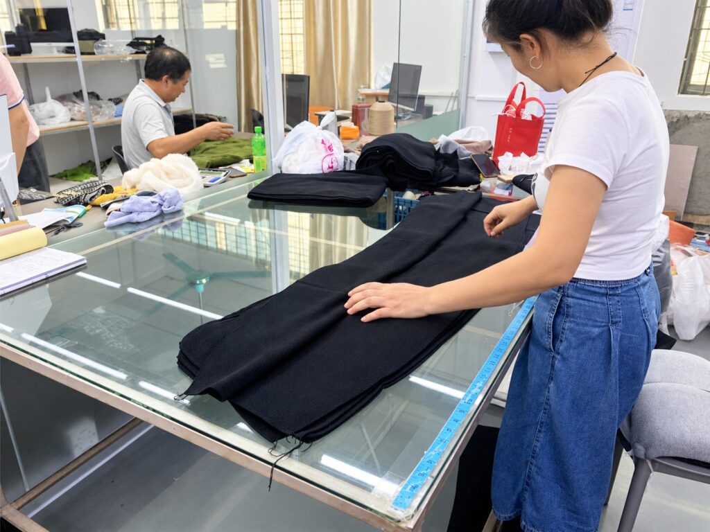 Wayhonk team members reviewing knitted panels.