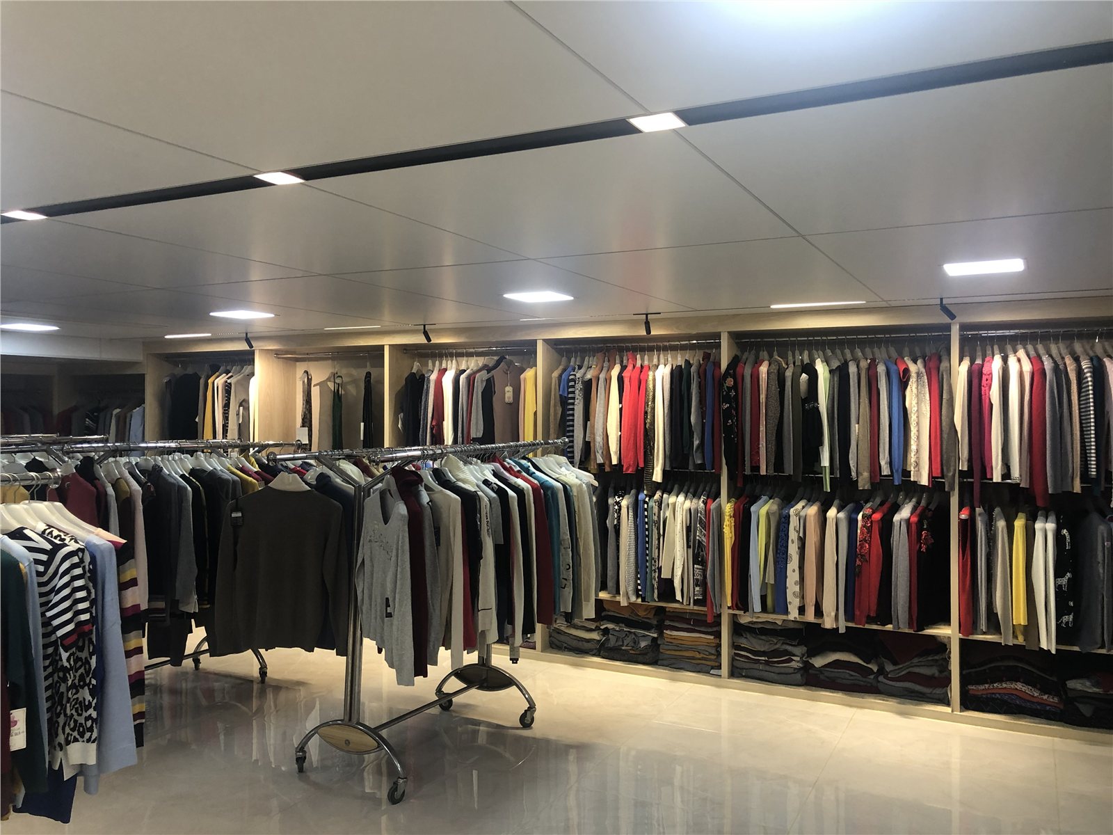 Knit garments on racks in the sample room.