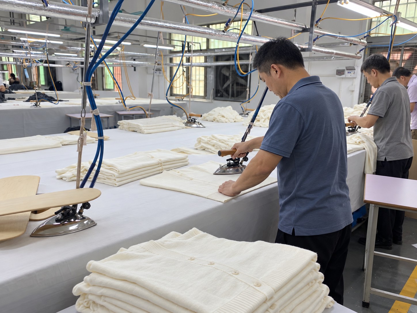 Steam pressing of cream knitwear