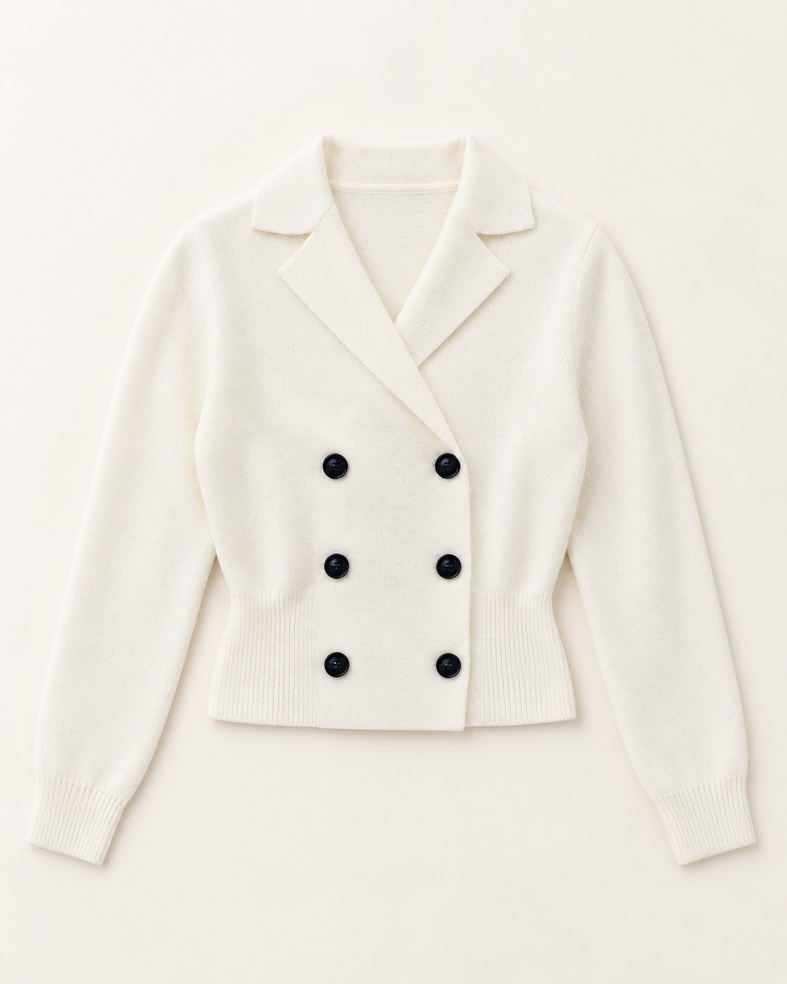 Flat presentation of a cream double-breasted knit jacket.